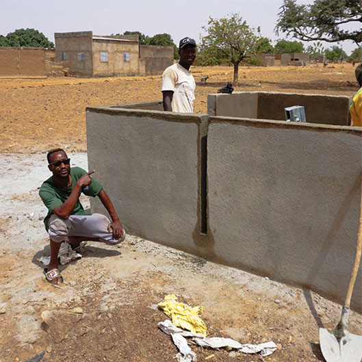 Community gathered during well construction in Zigla Pakala